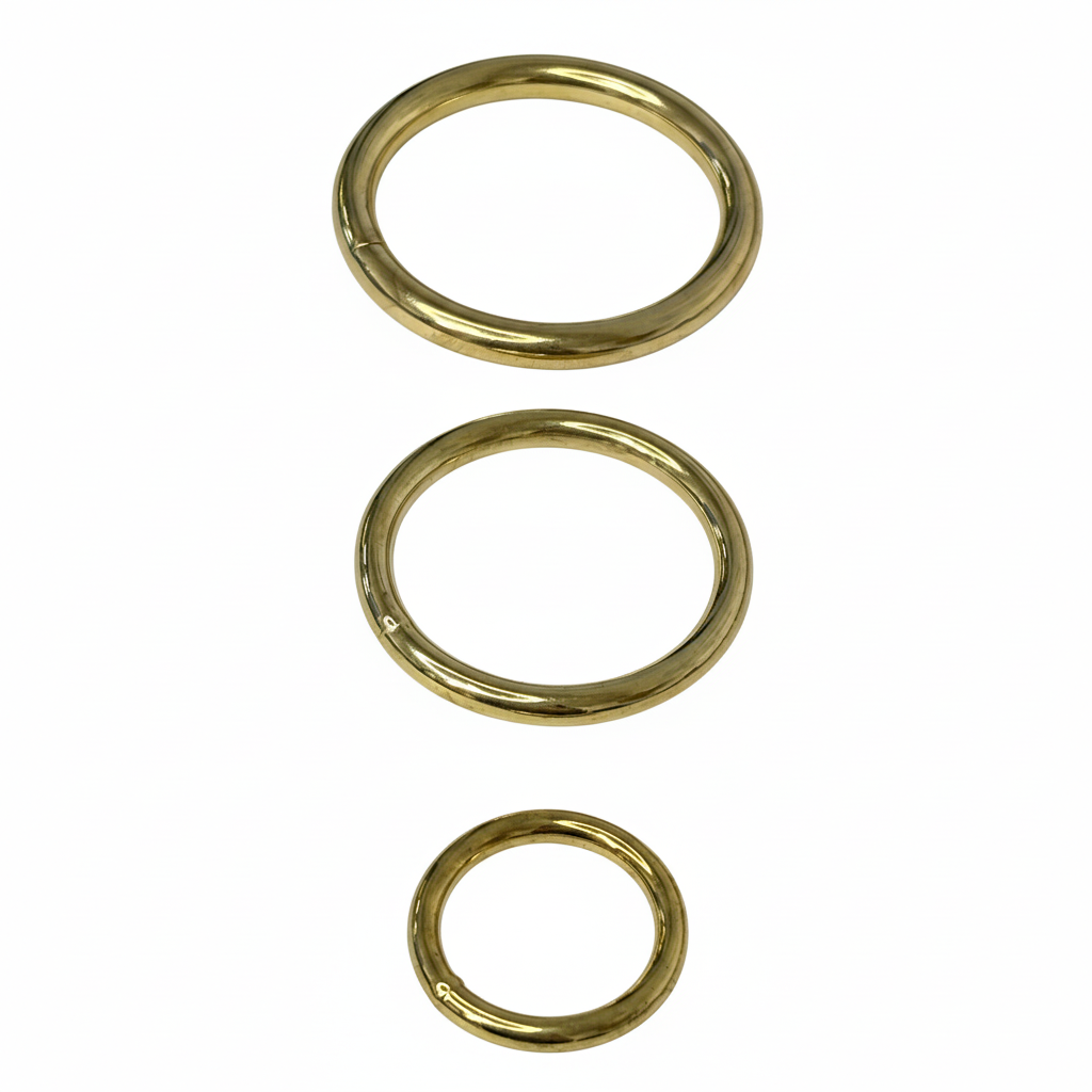 Three brass gold O-rings on brilliant white background