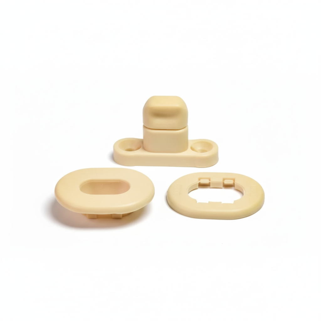 Cream plastic snap fastener components on white background