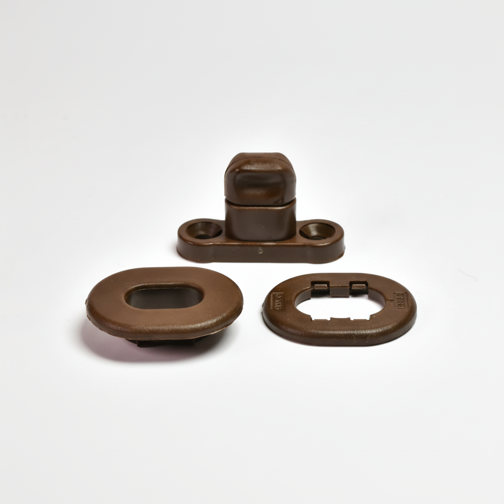 Brown plastic snap fastener components on white background